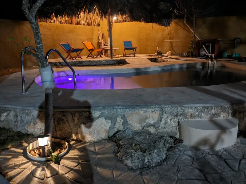 La alberca de noche, con luz de color.